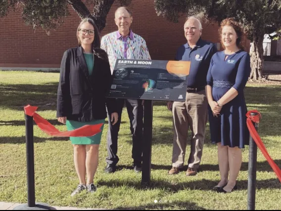 (From left to right) Zarah Brown standing next to new placard with Dr. Tim Swindle, Dr. Mark Marley, and Dr. Carmala Garzione.