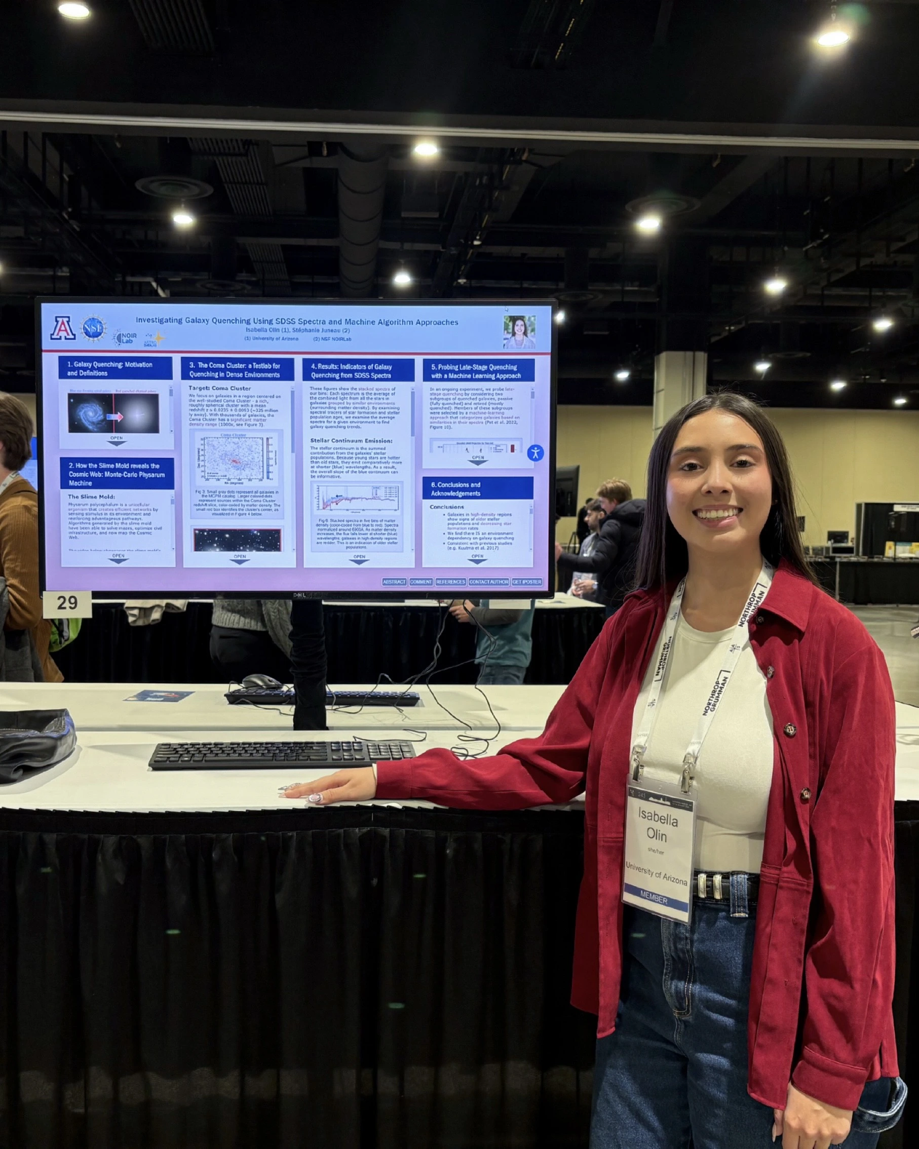 Isabella Olin stands in front of her digital poster at AAS conference