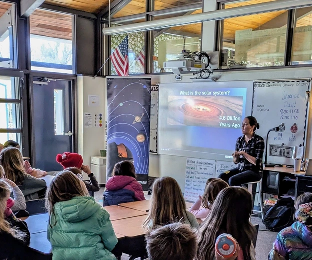 Zarah Brown sits in front of elementary school classroom